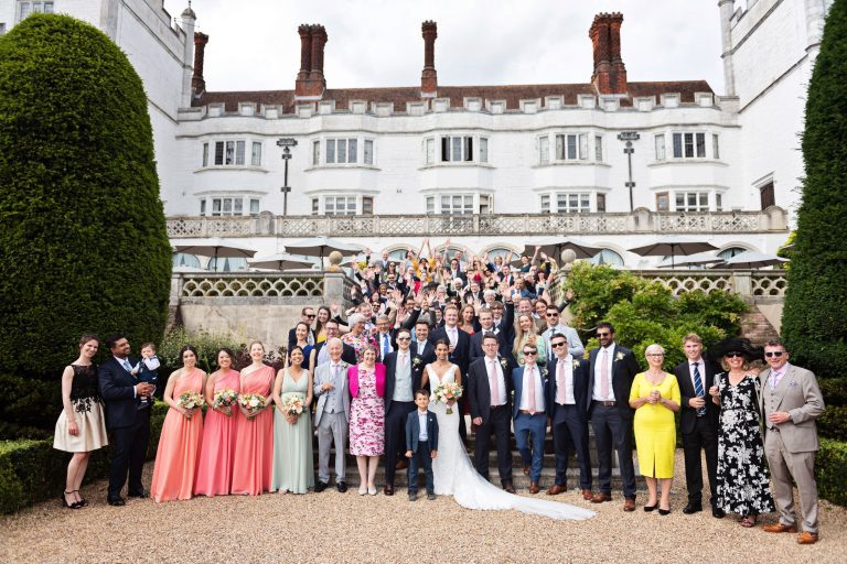 Large group photograph of everyone a wedding in the grounds at Danesfield House.