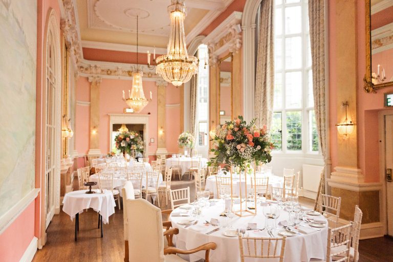 Wedding breakfast set up at Danesfield House. Chandeliers and ornate fixings make this look luxurious