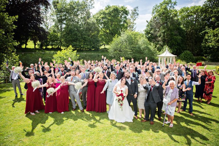 Large group shot of weddings guests smiling at Double Tree, Hilton, Cheltenham.