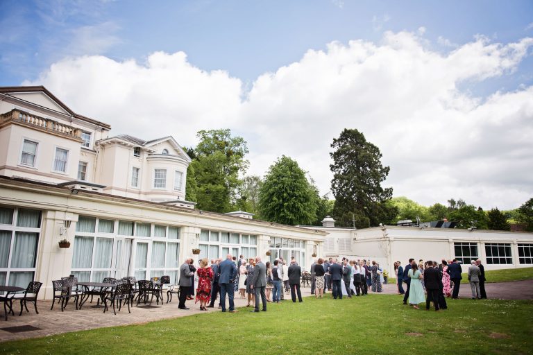 Outdoor scene of wedding guest chatting at Double Tree Hilton, Cheltenham