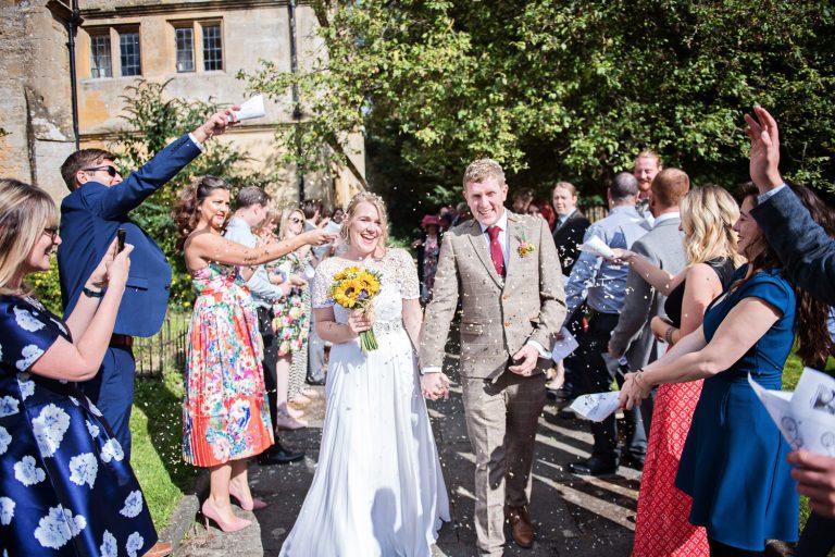 Bride and groom getting showered with confetti