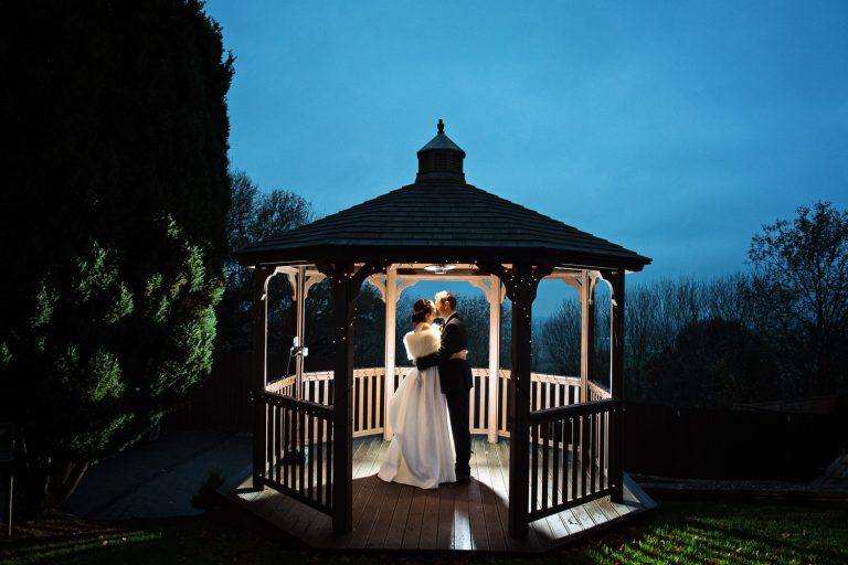 Night time shot of bride and groom being lit up in the dark.