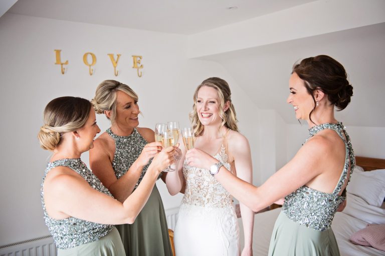 Team bride celebrate with a glass of fizz by getting ready on time.