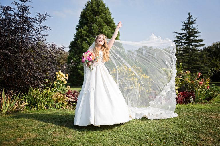 A bride shows of her wedding veil.