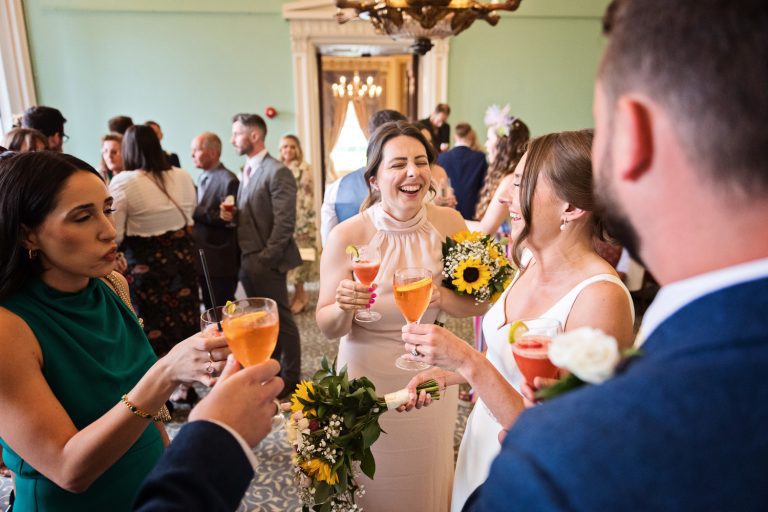 Candid phot of bride having fun and laughing with her with her wedding guests