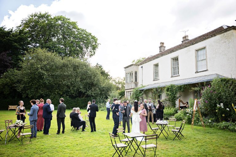 Overview of guests chatting naturally in the house gardens at the Matara.