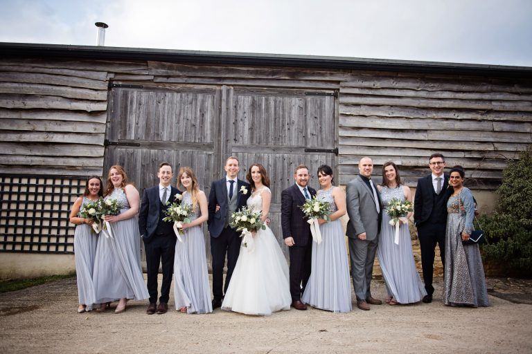 Bridal party stand by girl boy girl. Looks colourful.
