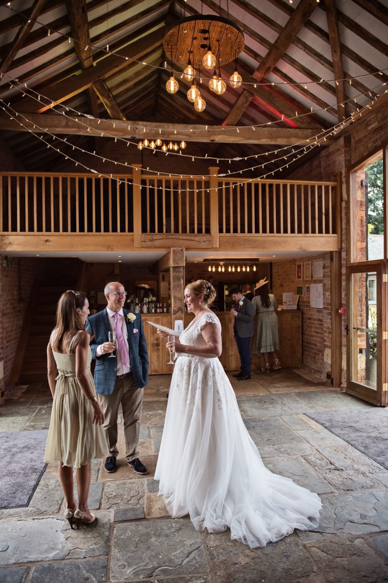 Bride & Groom chatting to wedding guests. Candid pic.