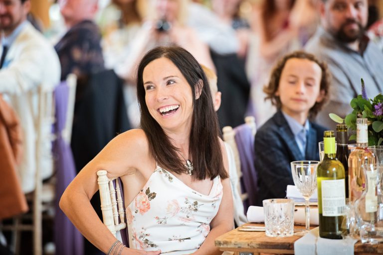 Wedding guest laughing. Candid photo.