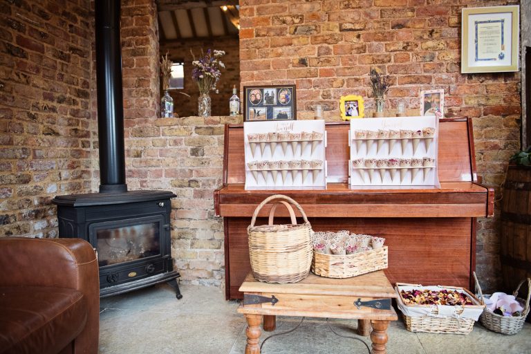 Wedding details such as confetti, frames of the couple. Laid in front of and on a piano. Very relaxed.