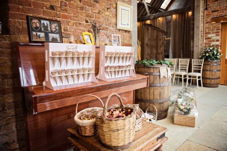 Wedding details such as confetti, frames of the couple. Laid in front of and on a piano. Very relaxed.