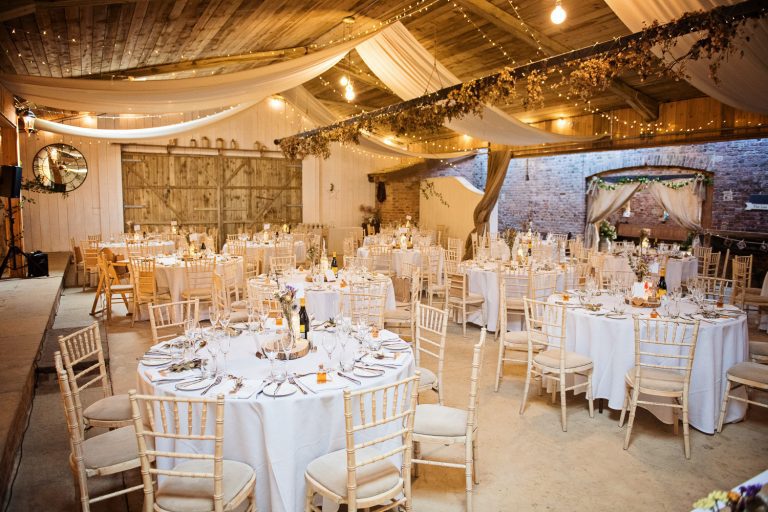 Wedding breakfast set up in a barn.