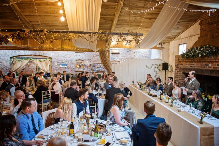 Speeches being made in the rustic barn at Milton End Farm.