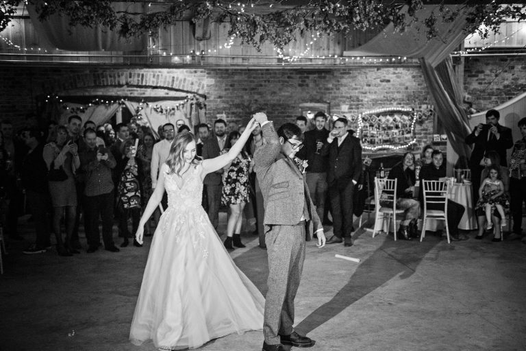 B&W photo of bride and groom doing their official first dance.
