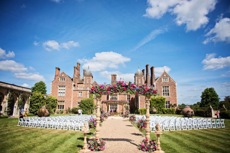 Hindu ceremony exterior set up in the gardens on a sunny day.