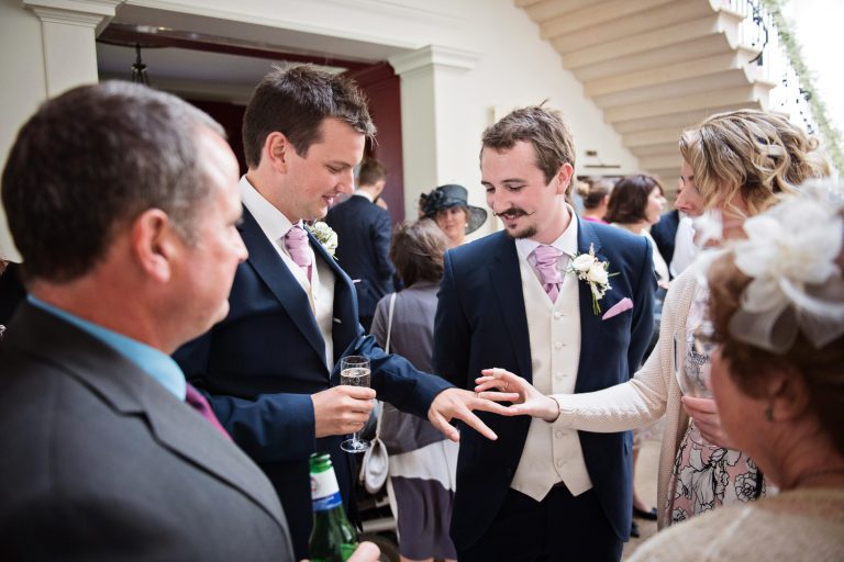 Candid photo of groom with his friends and family.