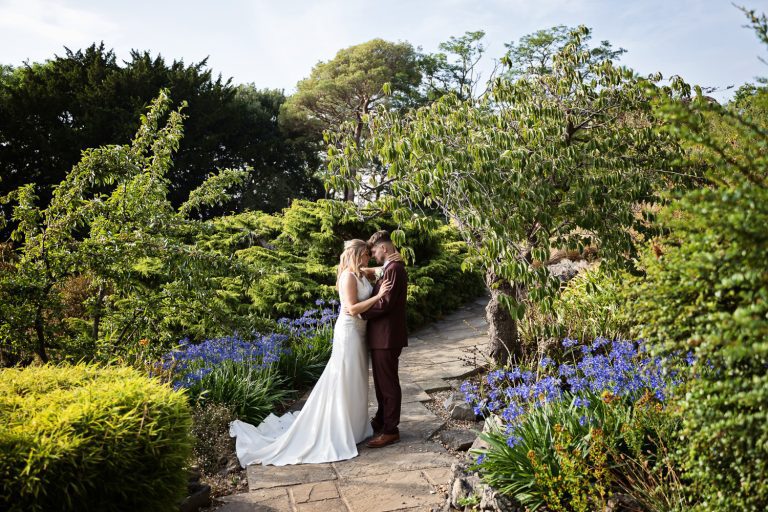 Bride and groom kiss in the gardens at Old Down Estate.