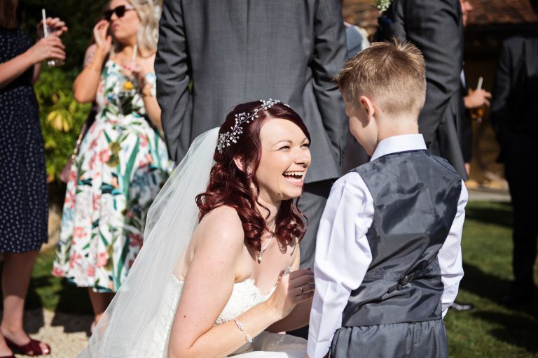 Bride chatting to a little human being.