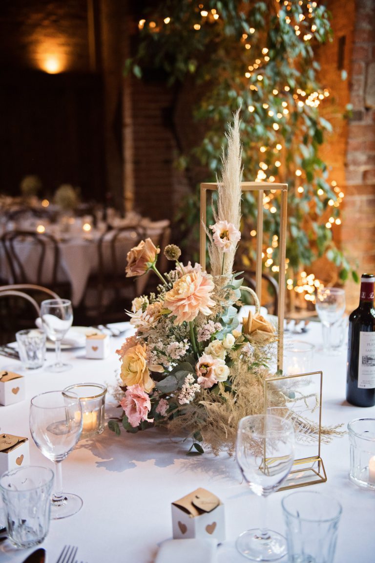 Floral display on a wedding breakfast table.