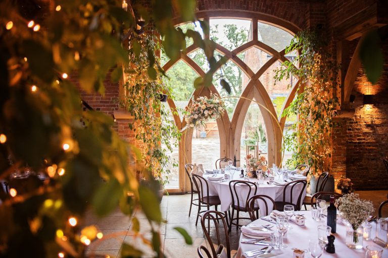 Wedding breakfast table setting with uplighting sparkly lighting at Shustoke Barn