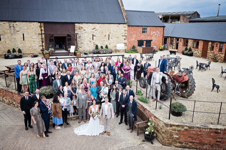 Large overview of Slapton Manor with bride and groom and entire wedding party.
