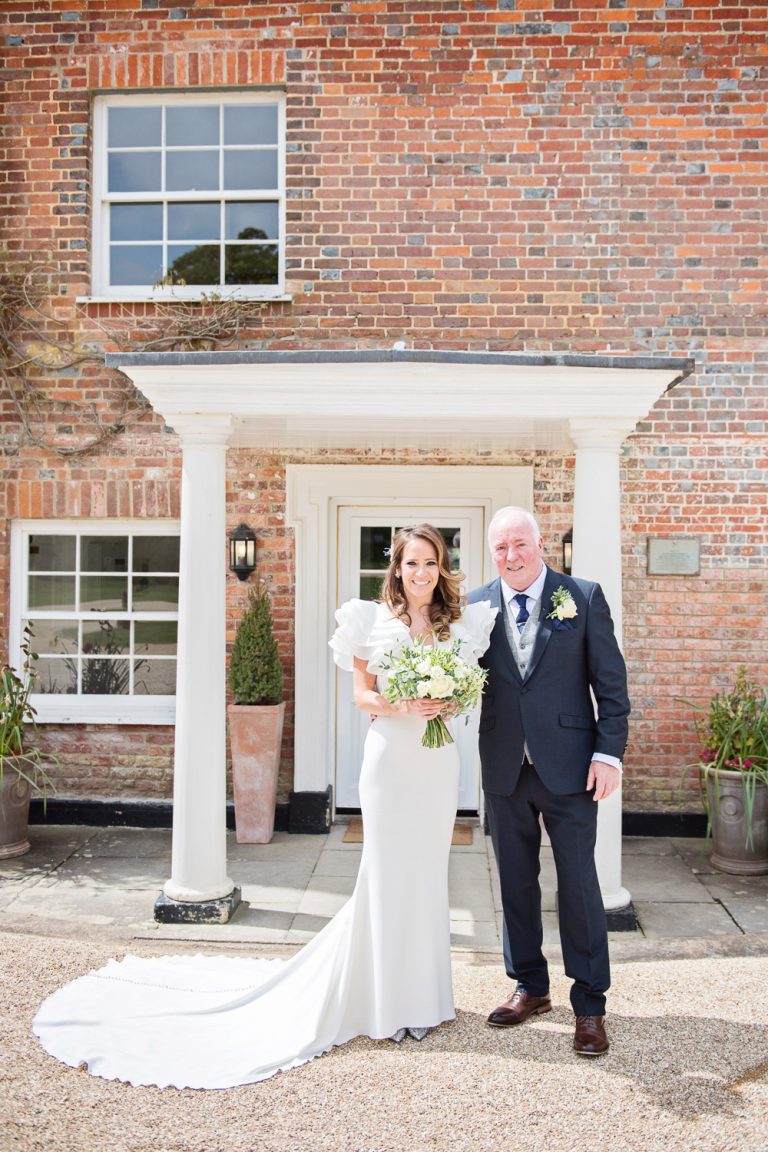 Portrait photo of the bride and her dad stood out the front of Syrencot wedding venue.