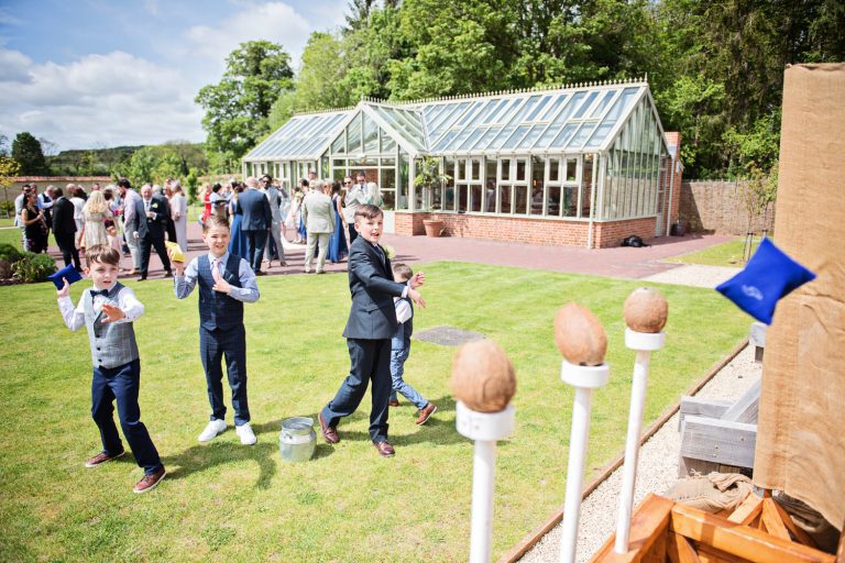 Story telling candid photo of kids throwing beanbags at the coconut stye.