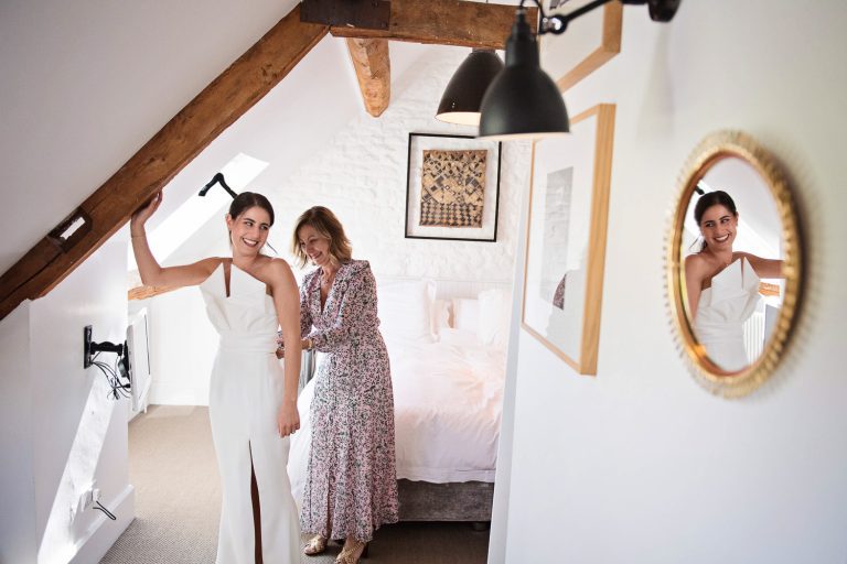 Storytelling photo of bride getting into her wedding dress.