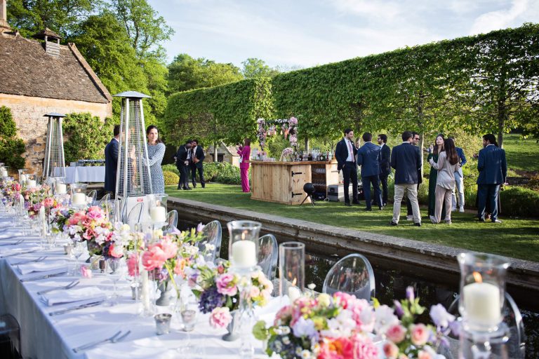 Wedding breakfast table laid out on the lawn at Temple Guiting Manor