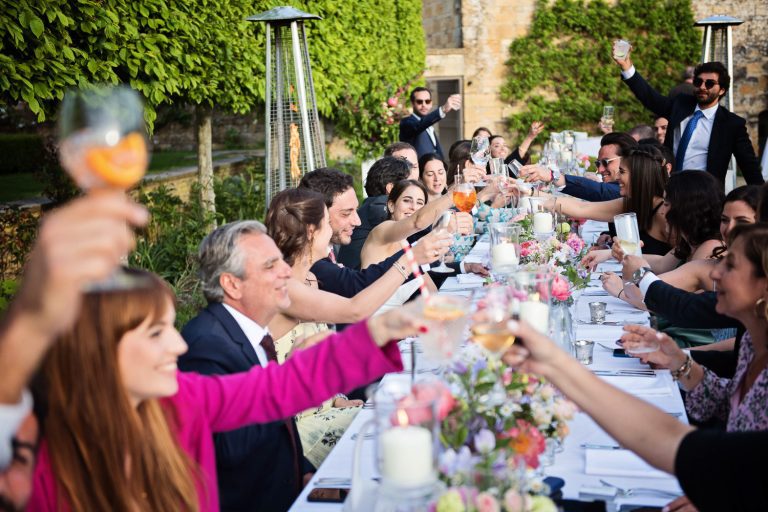 Wedding guest raise their glasses to celebrate the wedding.