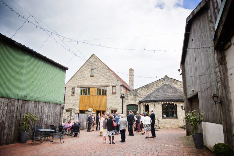 Overview of photograph of people mingling during a wedding reception at The Barn at Berkeley