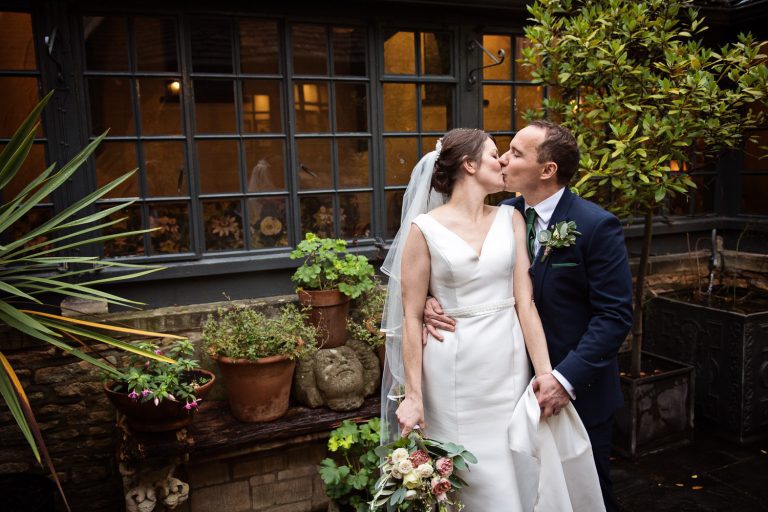 Bride and groom grabbing 5 min in the courtyard at The Bear at Rodborough.