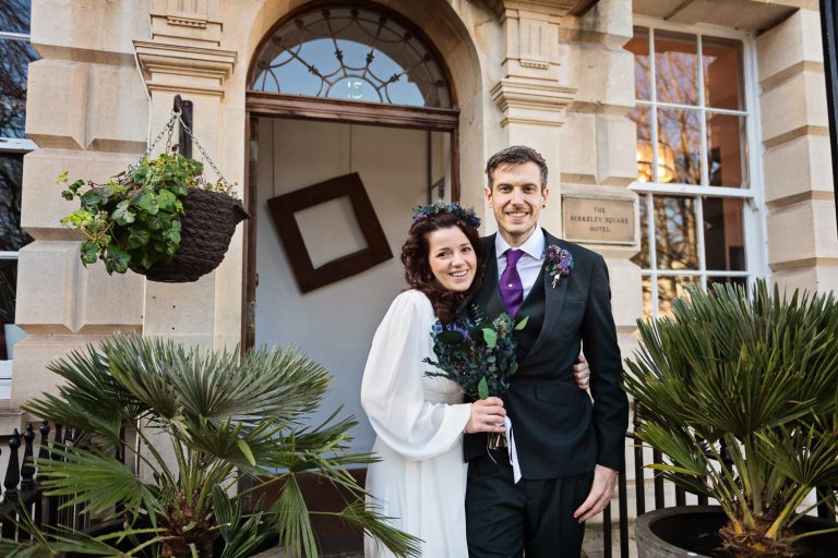 Relaxed photo of bride and groom outside The Berkeley Square Hotel.