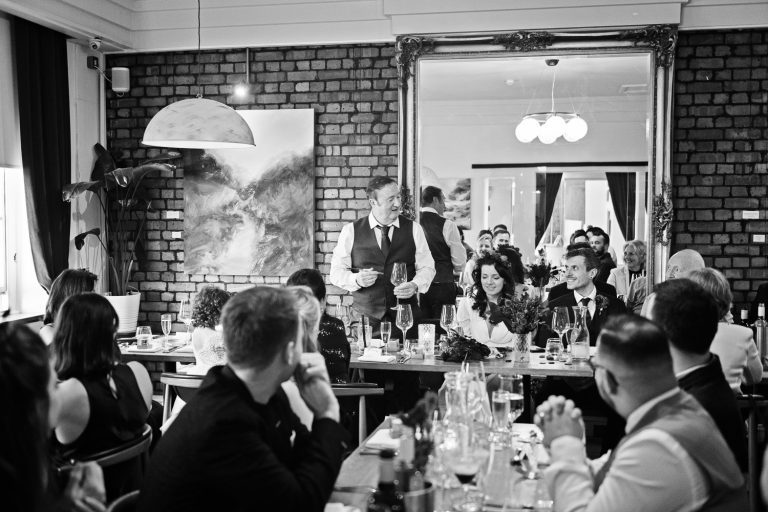 B&W candid photo of brides father delivering his father of the brides speech at The Berkeley Square Hotel.