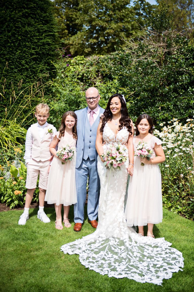 A family portrait of bride and groom and their nephews and nieces.