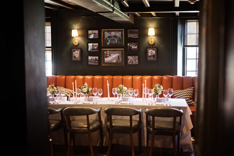Wedding breakfast set up. Candles lit and flowers and wine glasses.