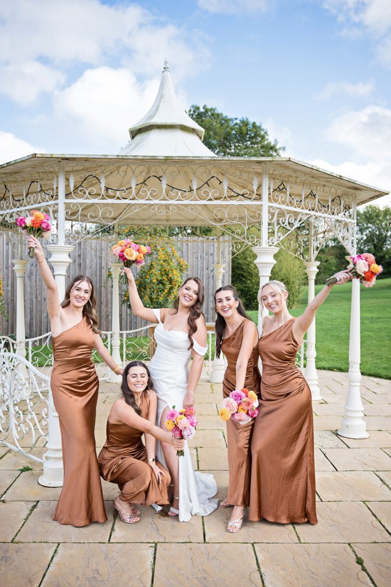 Bride and bridesmaids pose for the camera.