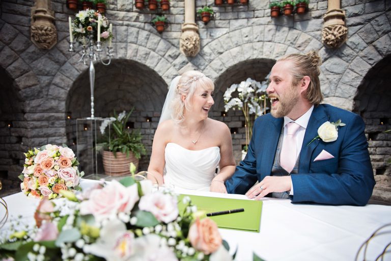Bride and groom sign their wedding register.