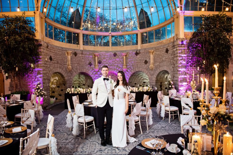 Bride and groom pose in The Orangery at Tortworth Court.