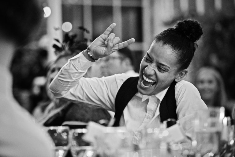 Candid b&w image of guests laughing.