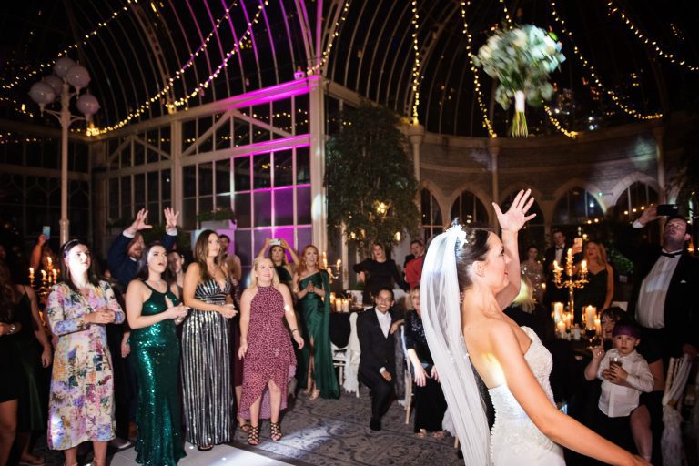 Documentary photo of bride throwing her bouquet.