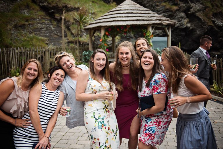 Candid fun photo of wedding guests fun posing in front of the camera.