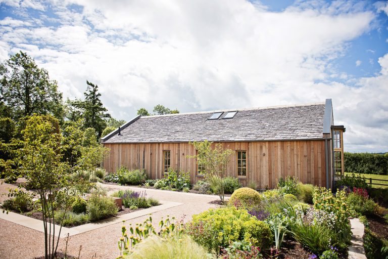 Hyde House Ceremony Barn in the summer. Gorgeous gardens.