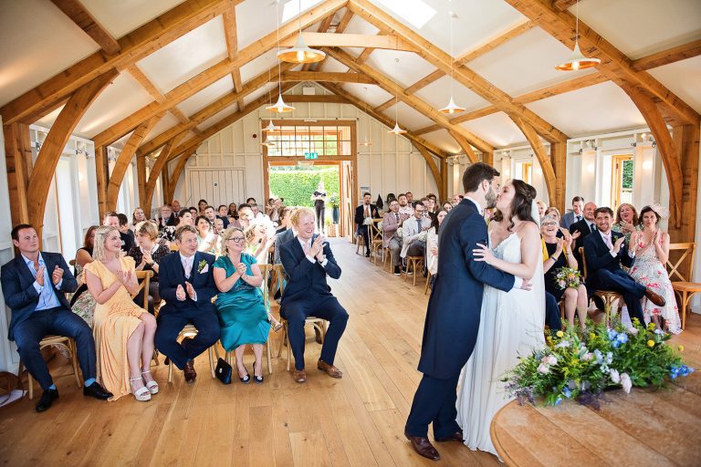 Bride and groom seal their wedding with a kiss at Hyde House.