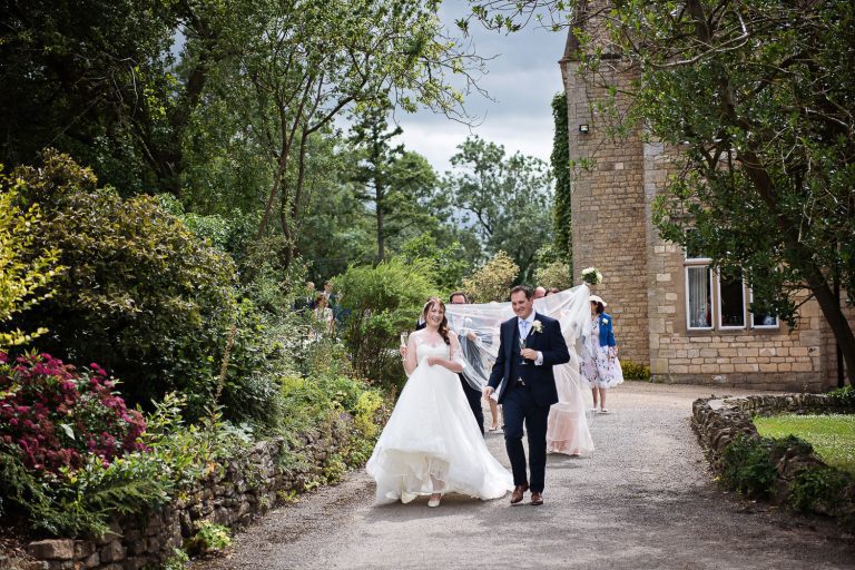 Bride and groom walking back from their wedding ceremony.