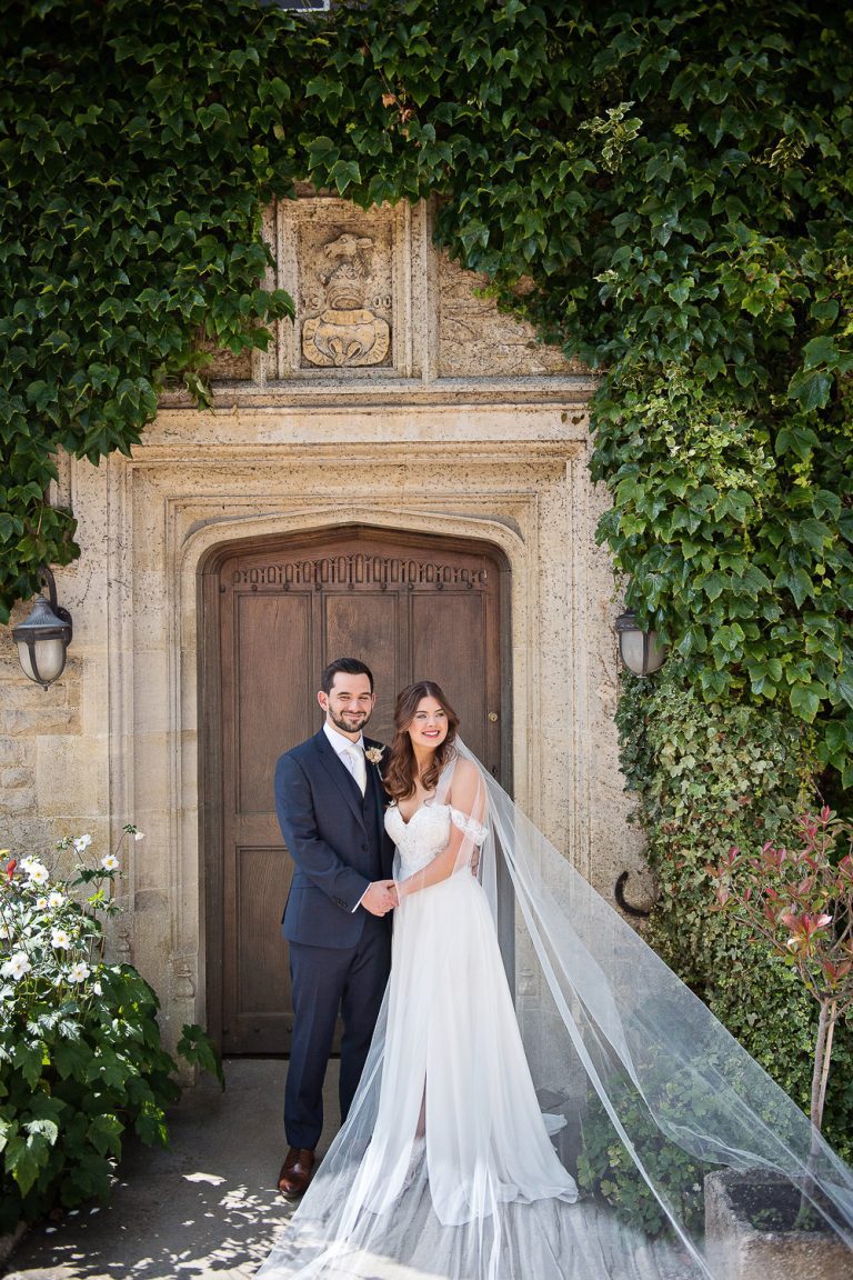 Portrait photo of bride and groom at the front door at Hyde House.