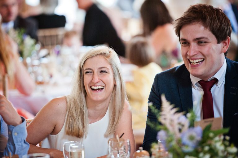 Candid photo of wedding guests having a good time and laughing.
