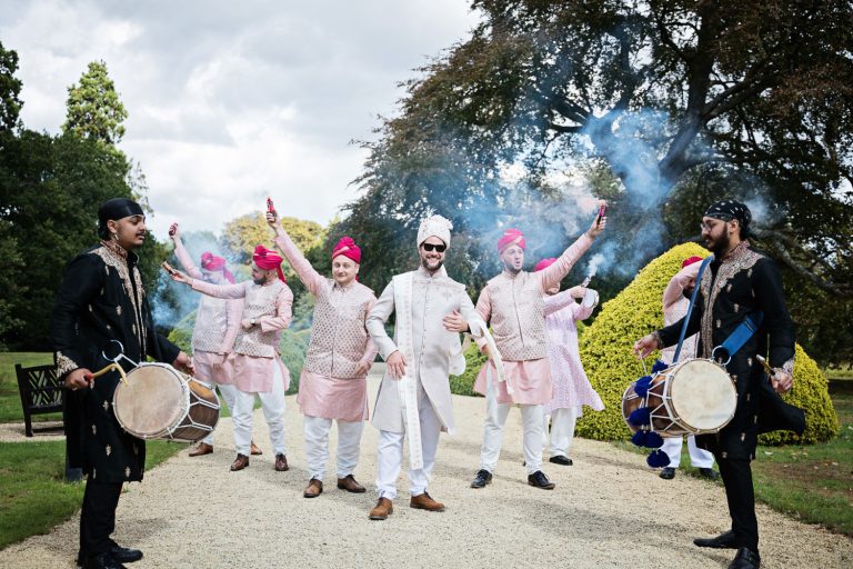 Groom and groomsmen get ready with smoke bombs and drums as they are about to start the Baraat.