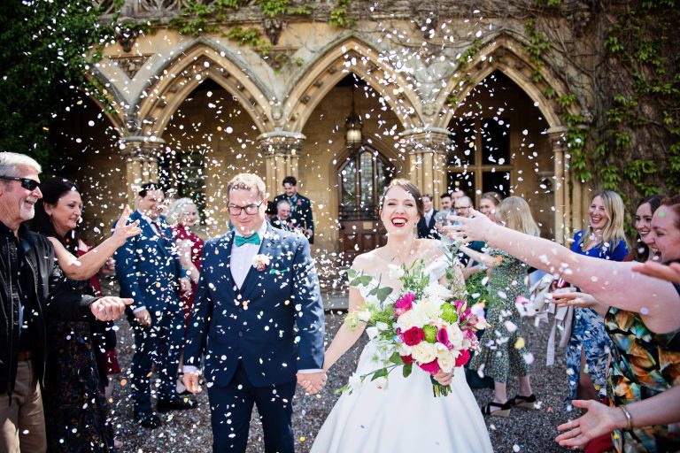 Bride and groom get showered by confetti by their friends and family at Manor By The Lake.