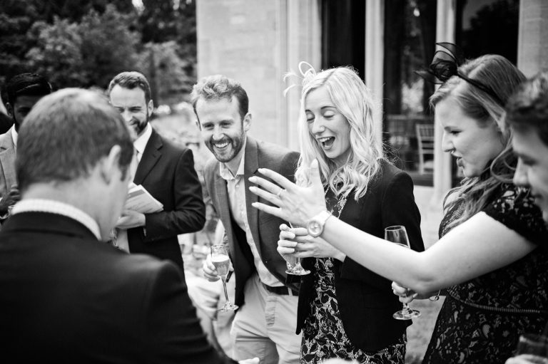 B&W candid photo of guests enjoying themselves.